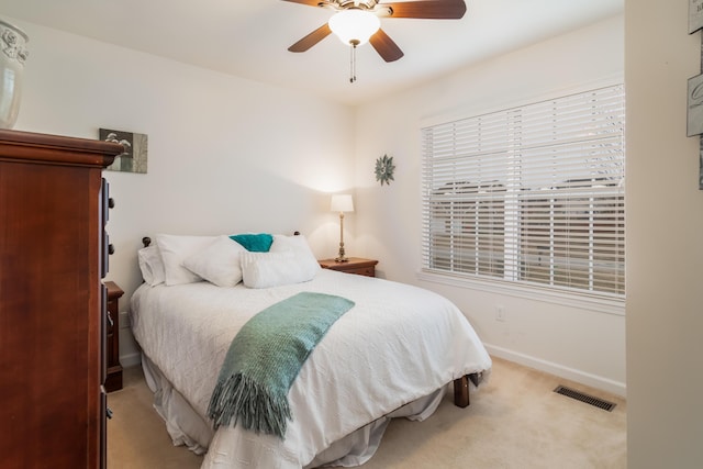 bedroom with light colored carpet and ceiling fan