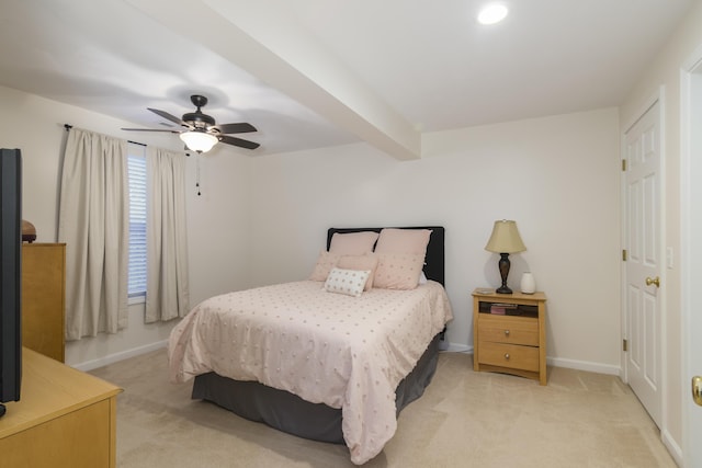 bedroom with beamed ceiling, ceiling fan, and light carpet