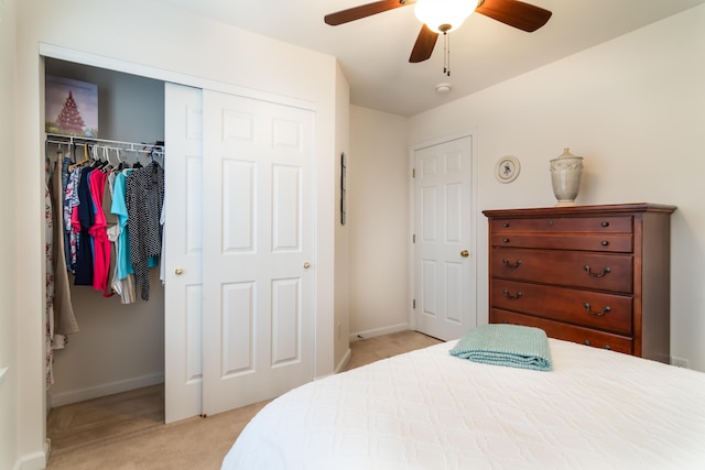 carpeted bedroom featuring ceiling fan and a closet