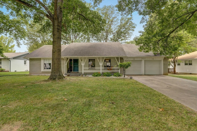 ranch-style house featuring a garage, a front lawn, and covered porch