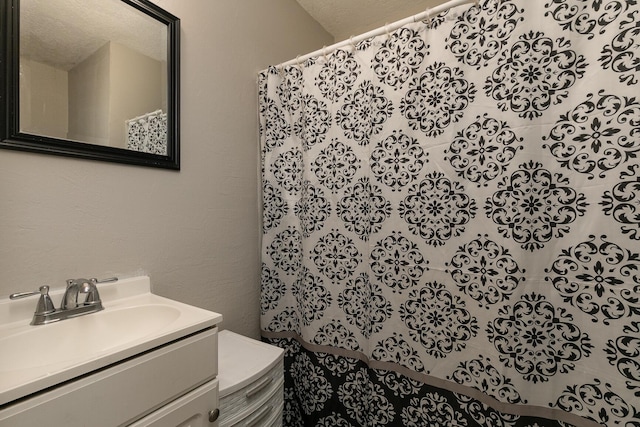 bathroom with vanity and a textured ceiling