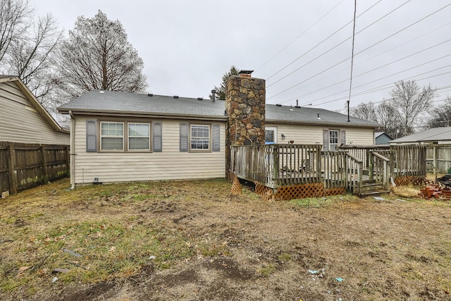 back of property featuring a wooden deck