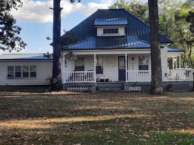 view of front of home with covered porch and a front yard