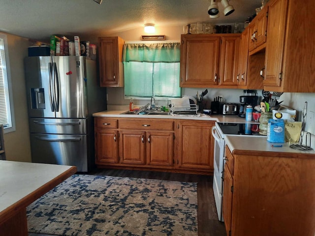 kitchen featuring sink, dark wood-type flooring, white range with electric stovetop, and stainless steel refrigerator with ice dispenser