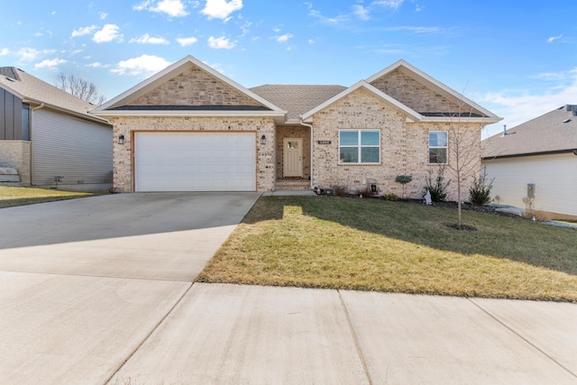 view of front of home featuring a garage and a front lawn