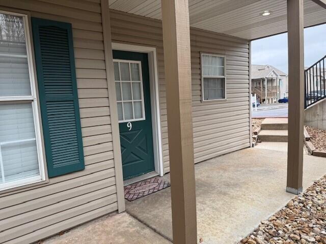 view of exterior entry with a porch