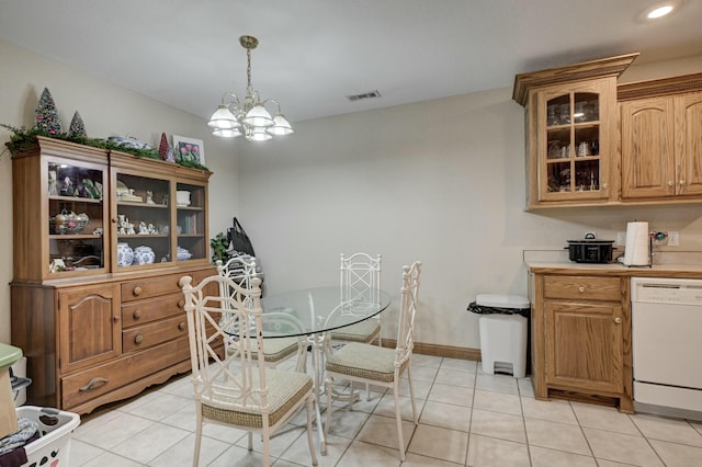 dining room with light tile patterned flooring and a chandelier