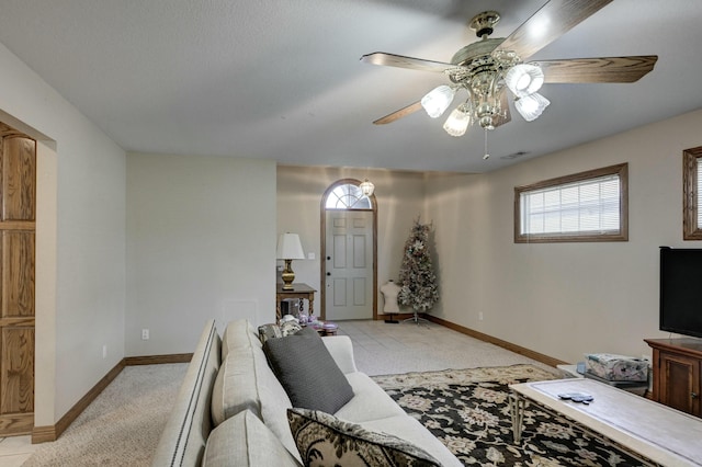 carpeted living room featuring ceiling fan