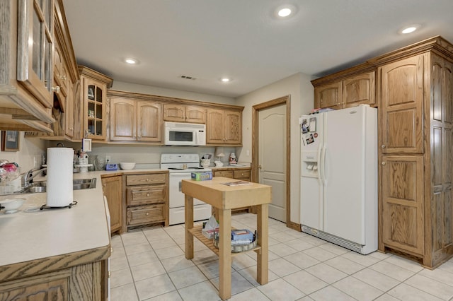 kitchen with white appliances and light tile patterned flooring