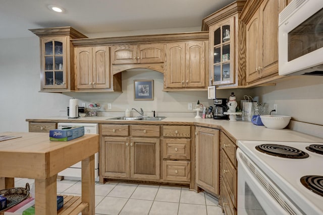 kitchen with sink, white appliances, and light tile patterned floors