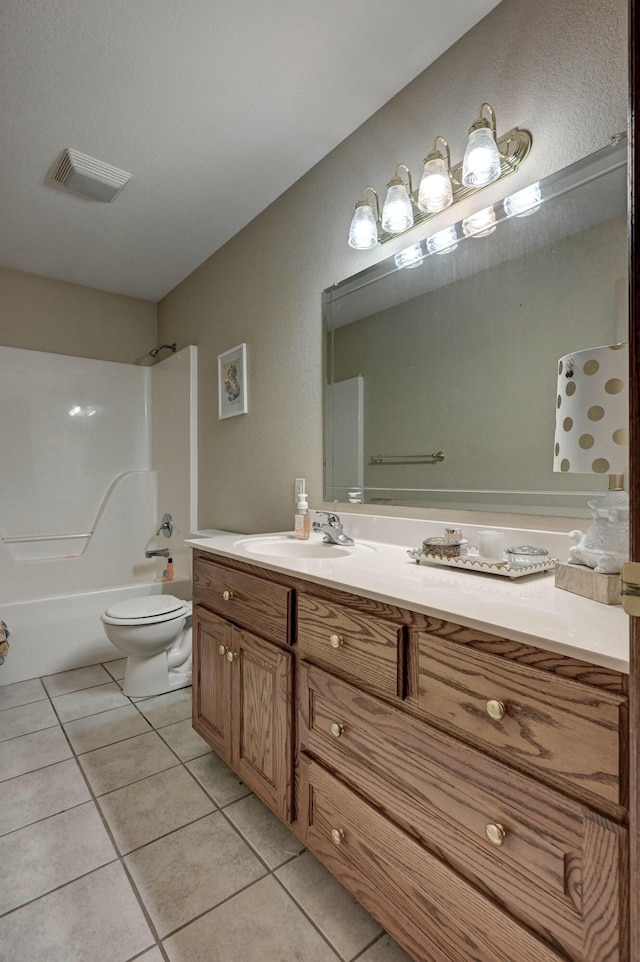 full bathroom featuring vanity, shower / washtub combination, tile patterned floors, and toilet