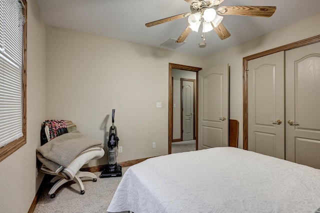 carpeted bedroom with a closet and ceiling fan