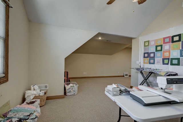 carpeted home office with lofted ceiling and ceiling fan