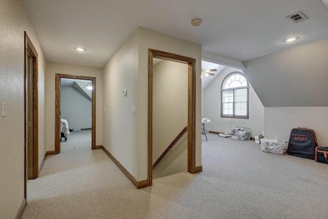 additional living space with light carpet, vaulted ceiling, and ceiling fan