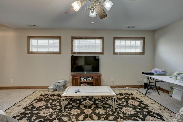 carpeted living room featuring ceiling fan