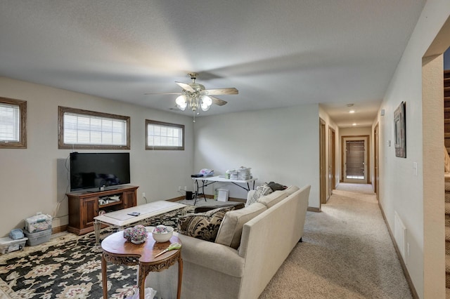 carpeted living room featuring ceiling fan