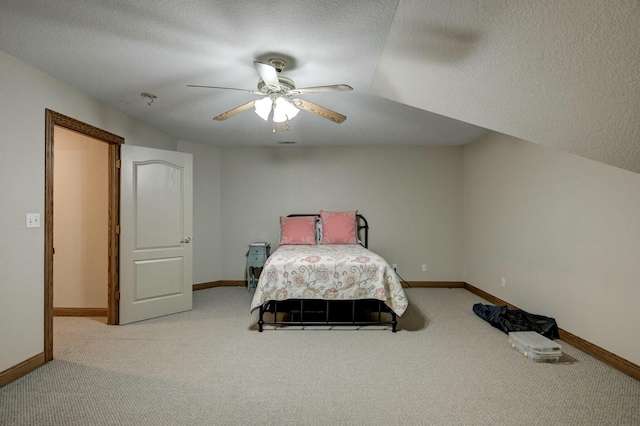 bedroom featuring ceiling fan, carpet floors, and a textured ceiling