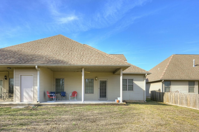 rear view of property featuring a patio and a yard