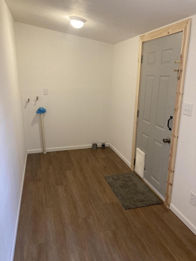 clothes washing area with dark hardwood / wood-style floors