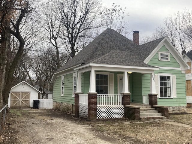 view of front of house with covered porch and a storage unit