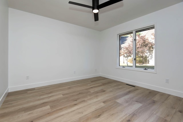 empty room featuring ceiling fan and light hardwood / wood-style flooring