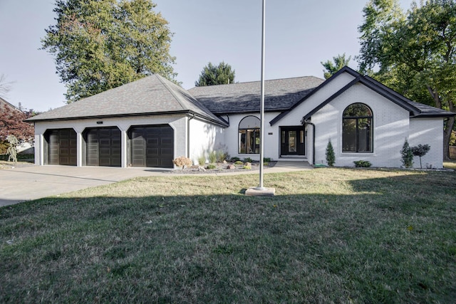 view of front of home with a garage and a front yard