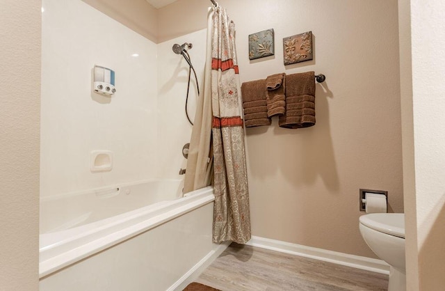 bathroom featuring wood-type flooring, toilet, and shower / bath combo with shower curtain