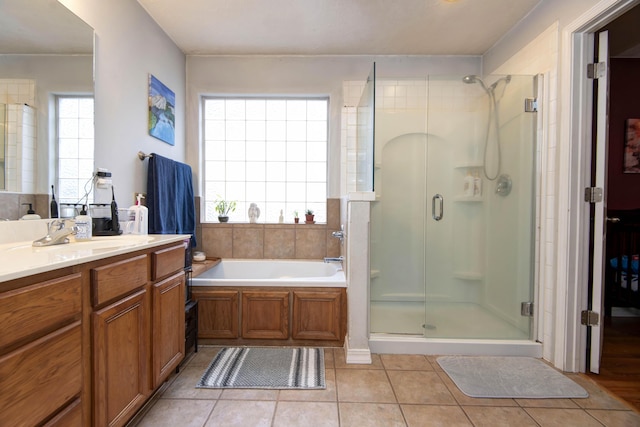 bathroom with vanity, plus walk in shower, and tile patterned flooring