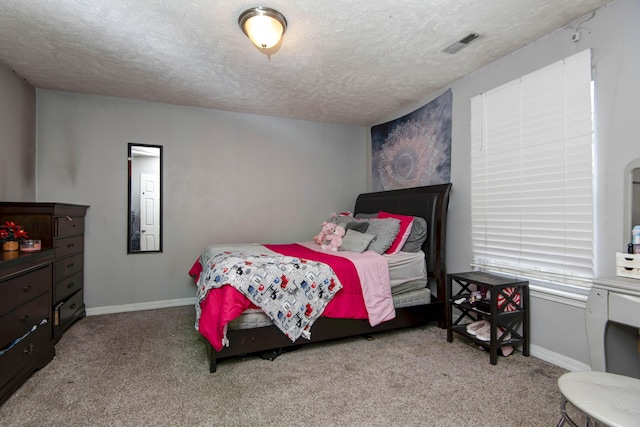 carpeted bedroom featuring a textured ceiling