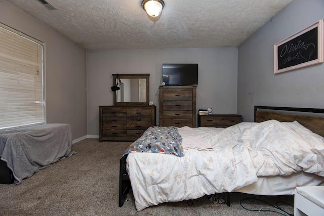 carpeted bedroom featuring a textured ceiling