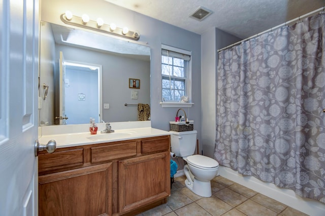 full bathroom featuring vanity, shower / bath combination with curtain, a textured ceiling, tile patterned floors, and toilet