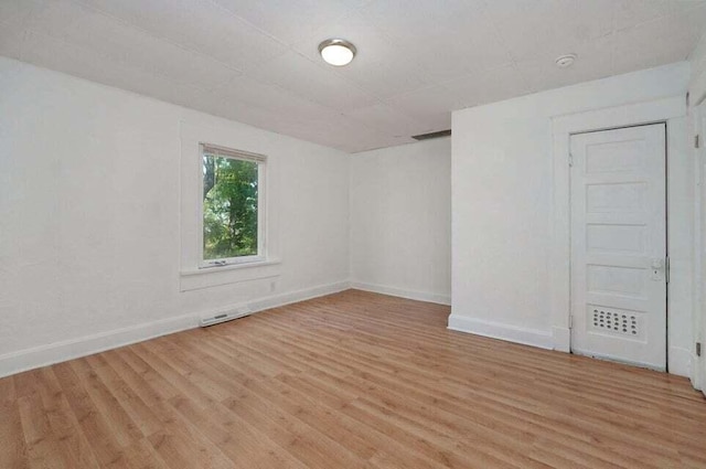 unfurnished room with light hardwood / wood-style floors