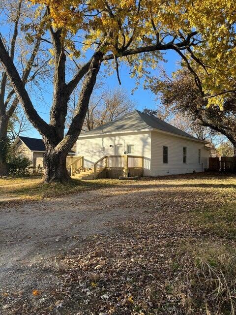 view of side of home with a wooden deck