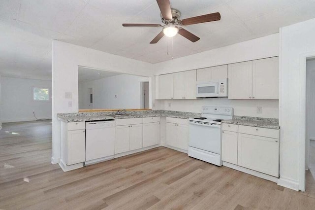 kitchen with white cabinets, white appliances, and light hardwood / wood-style flooring