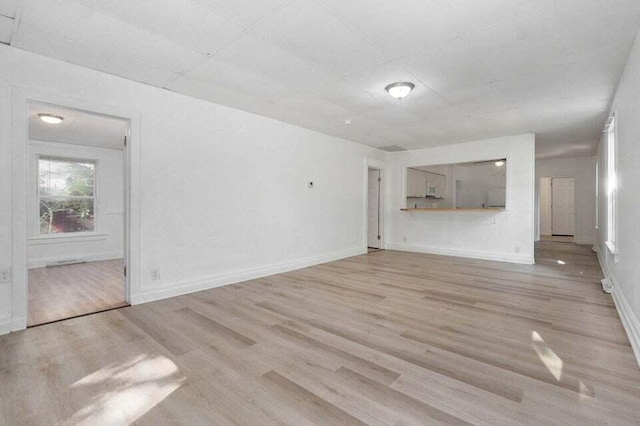 unfurnished living room with light wood-type flooring