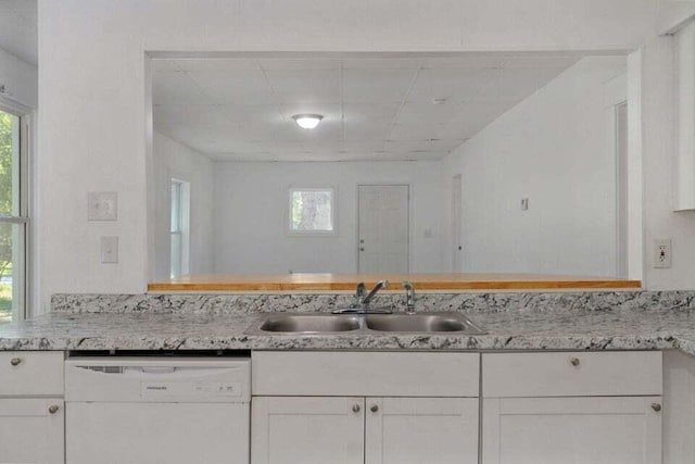 kitchen with white cabinetry, sink, and dishwasher