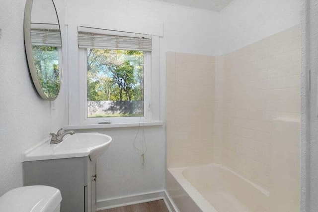 full bathroom featuring hardwood / wood-style flooring, vanity, shower / bathing tub combination, and toilet