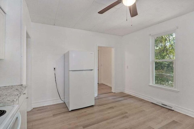 kitchen featuring range, light hardwood / wood-style flooring, white refrigerator, ceiling fan, and white cabinets