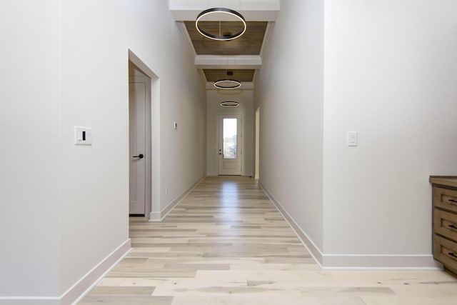 hallway with light hardwood / wood-style floors