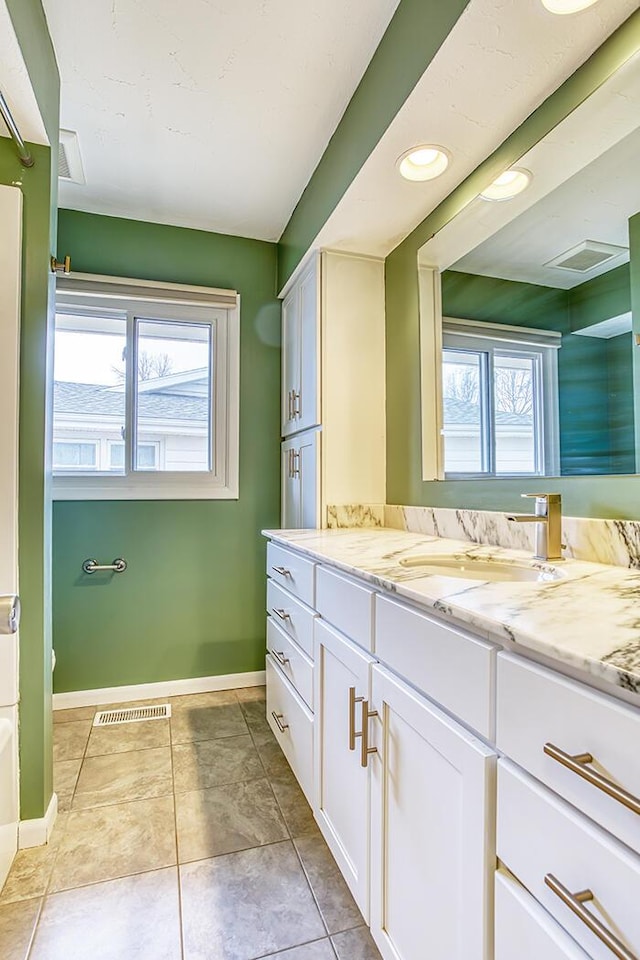 bathroom with tile patterned flooring and vanity