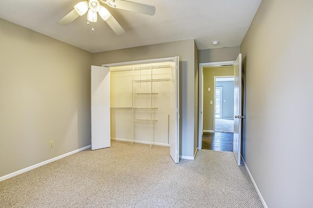 unfurnished bedroom with ceiling fan, a closet, and light carpet