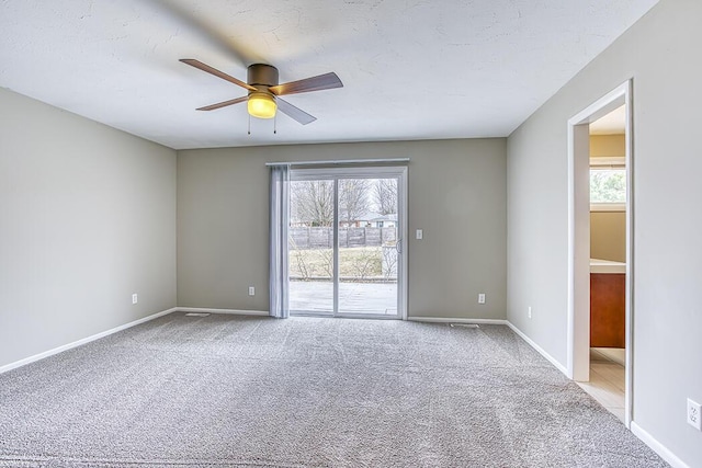 unfurnished room featuring light carpet, a textured ceiling, and ceiling fan