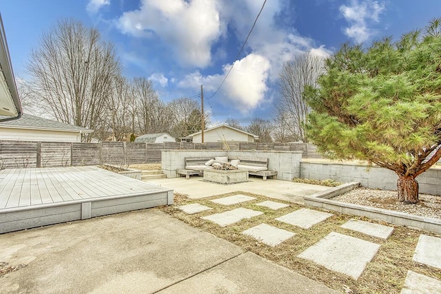 view of patio with a deck and an outdoor fire pit