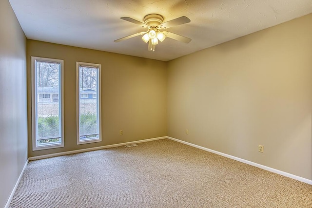 carpeted empty room featuring ceiling fan