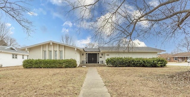 ranch-style home with a front lawn