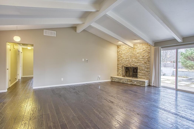 unfurnished living room featuring a stone fireplace, dark wood-type flooring, and lofted ceiling with beams