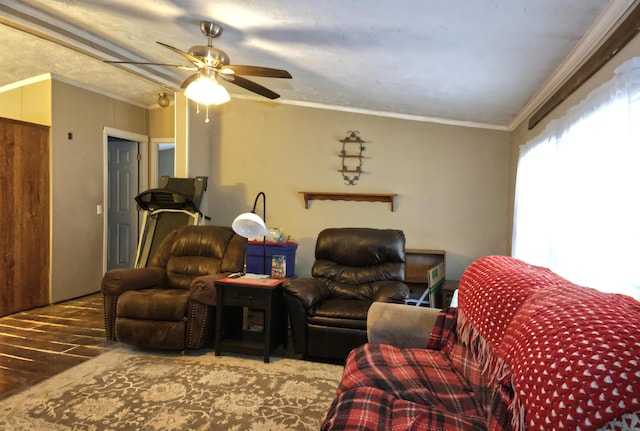 living room with lofted ceiling, hardwood / wood-style floors, ornamental molding, and ceiling fan