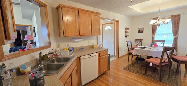 kitchen with pendant lighting, sink, white dishwasher, a chandelier, and light wood-type flooring