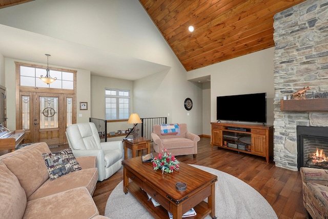 living room with a fireplace, dark wood-type flooring, wooden ceiling, and high vaulted ceiling