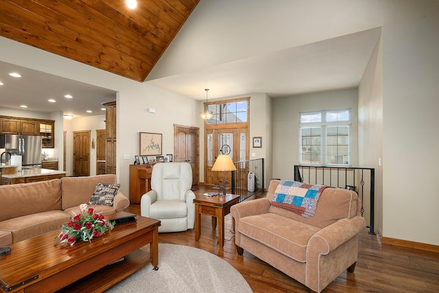 living room with a notable chandelier, dark hardwood / wood-style floors, wood ceiling, and high vaulted ceiling